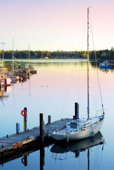 Yacht at the wooden dock in early morning in Tobermory Ontario Canada