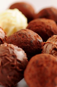 Several assorted gourmet chocolate truffles close up