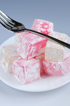 Turkish delight (lokum) confection on a white dessert plate