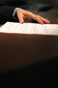 female manager hand on contract before signing it, selective focus on hand