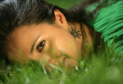 The girl in a grass. The face close-up