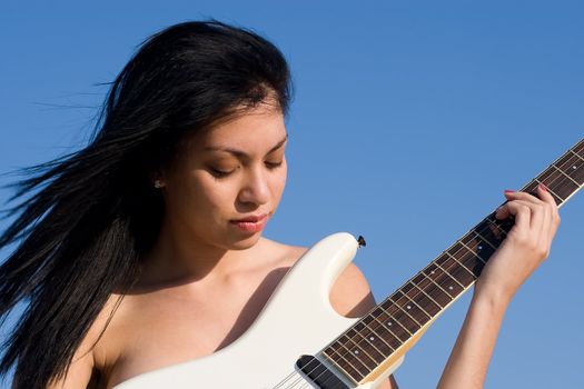 Nude Girl playing music on a guitar