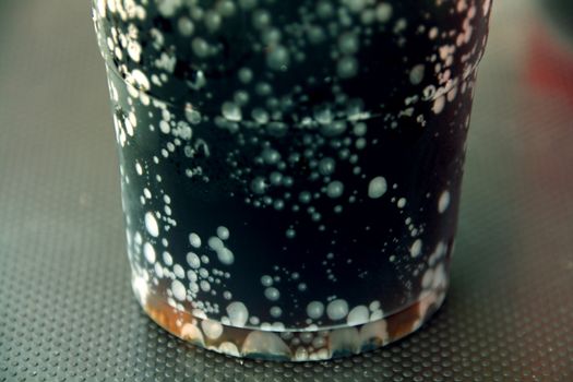 macro of a refreshing glass of drink at a summer day on a table.