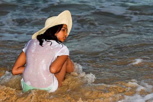 Caribbean girl in wet t-shirt with a hat on