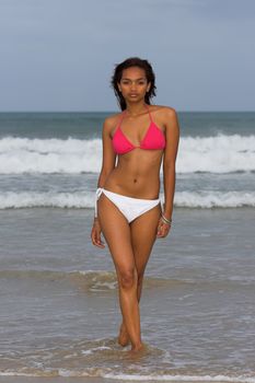 Ethnic Bikini model wearing pink and white bikini