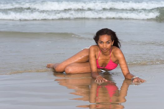 Caribbean girl posing in a pink and white bikini