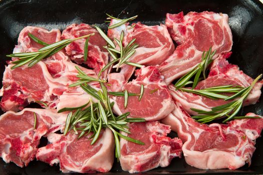 Racks of lamb, ready for cooking, with fresh rosemary