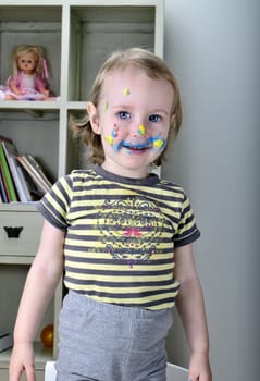 funny little girl and colored paints