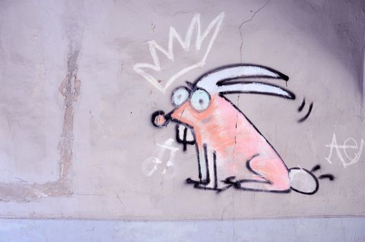 Graffiti on the wall. Crowned bunny with big teeth.