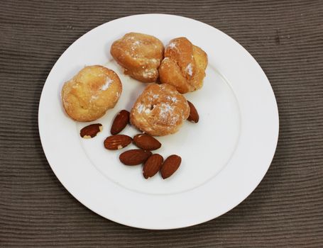 delicious small cakes with almond on the white plate