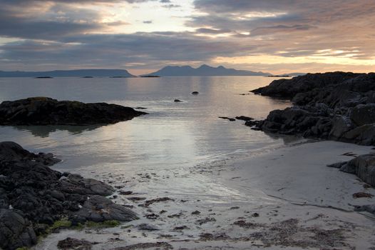 Sunsetting over the sea at Arisaig Scotland with the islands of Rum and Eigg in the distance at the beach where Local Hero was filmed