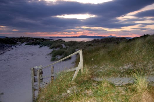Sunset and boardwalk at Arisaig looking over toward the island of Skye, Scotland
