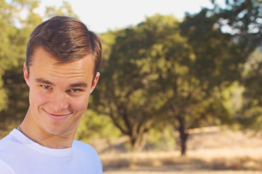 Young man with trees in background