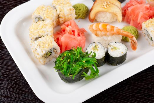 japanese sushi set and sushi with green seaweed closeup in the foreground