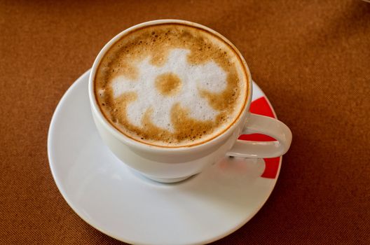 Cappuccino coffee cup closeup at the table