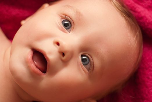 lying pretty funny baby boy closeup portrait