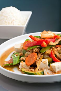 Fresh Thai food stir fry with tofu and white jasmine rice. 