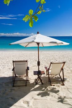 Deckchairs on the beach in front of the lagoon