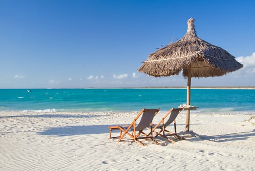 Relax on the beach, deck chair, parasol and lagoon