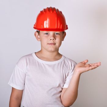 Portrait of a boy in a red protective helmet