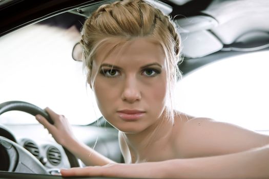  Young beautiful woman driving a car.   