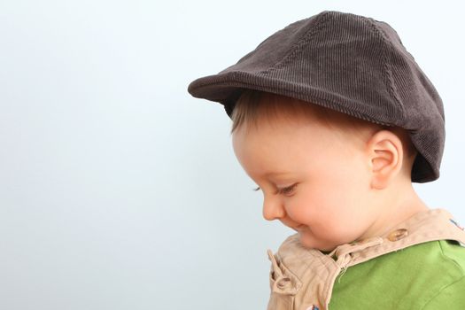 Adorable baby boy wearing a stylish hat