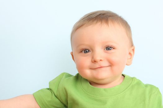 Beautiful portrait of a baby boy wearing a green shirt