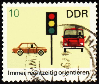 GDR - CIRCA 1960s: a stamp printed in GDR (East Germany) shows car, truck and light signal, devoted to the explaining rules of the road, circa 1960s