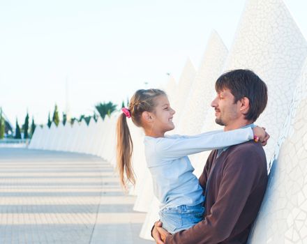 Happy father with his dauther walking of modern building. Valencia Spain