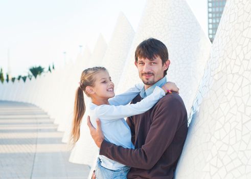 Happy father with his dauther walking of modern building. Valencia Spain