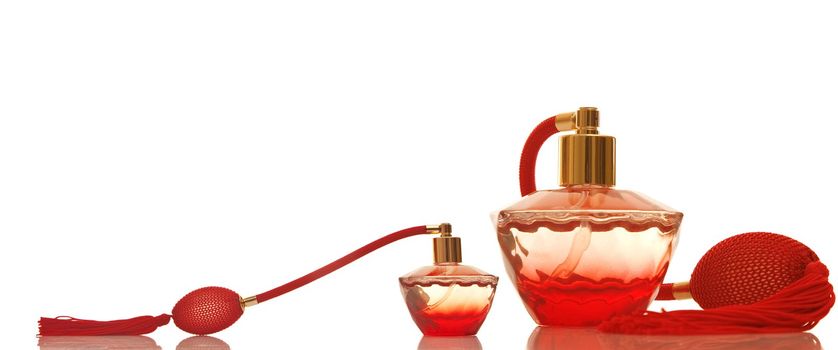 Perfume in a red glass bottles on white background