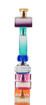 Tower made from perfume bottles on white background