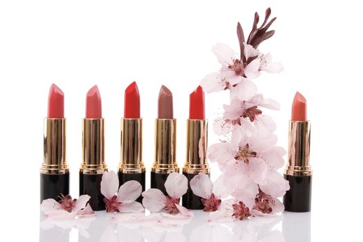different red lipstick and cherry flower, beauty concept on white background