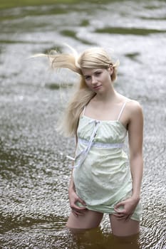 Young woman on a summer day in the river.