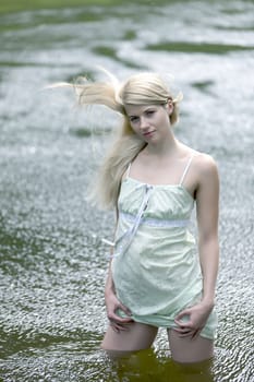 Young woman on a summer day in the river.