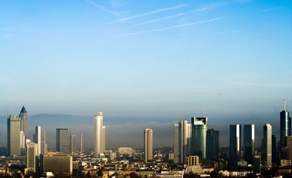 Frankfurt's Skyline illuminated by the morning light and siloutted against the early morning's fog.