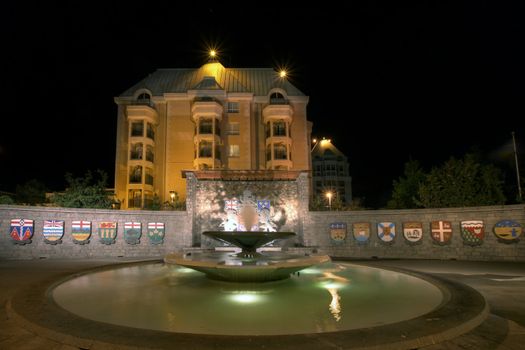 Confederation Garden Court Fountain in Victoria BC Canada with Code of Arms at Night