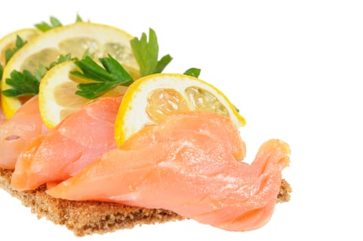 Sandwich snack - salmon with lemon on rye bread. Isolated on white.