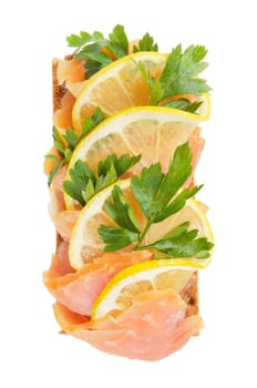 Sandwich snack - salmon with lemon on rye bread. Isolated on white.