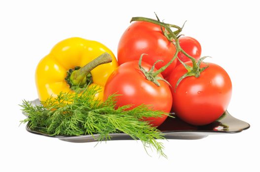 Vegetables - Tomatoes, peppers on a plate with dill. Isolated on white.
