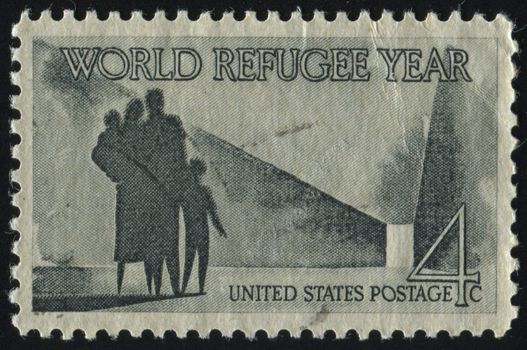 UNITED STATES - CIRCA 1960: stamp printed by United states, shows Refugee Family Walking Toward New Life, circa 1960.