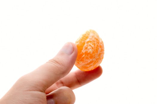 Man hand hold mandarin segment on white background