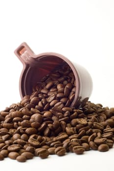 Cup with coffee beans on white