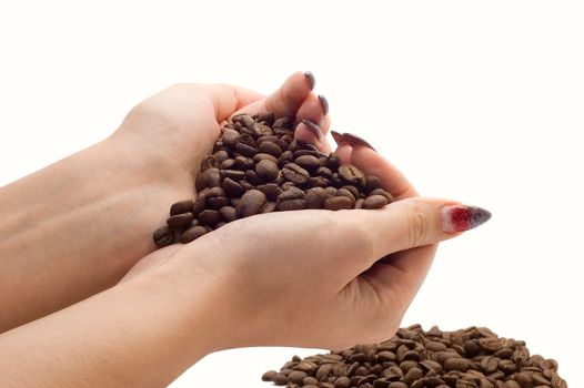 Female hands and coffee beans on white