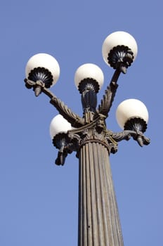 Antique lamp with five large bubbles. Park scenery.