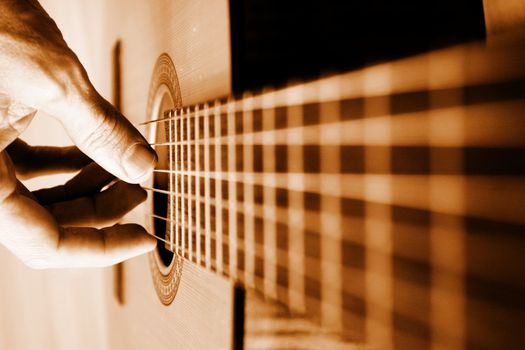 Acoustic guitar player close-up with focus on the player