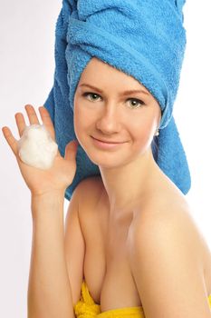 beautiful smiling young woman in towel on white background