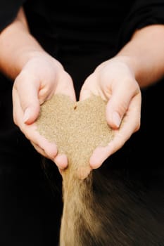 sand running through hands as a symbol for time running, lost etc.............