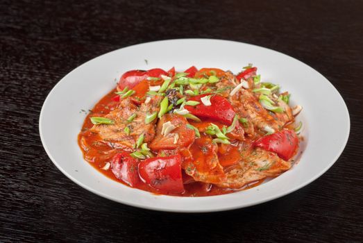 pork meat with tomato, pepper, prunes, garlic and green onion