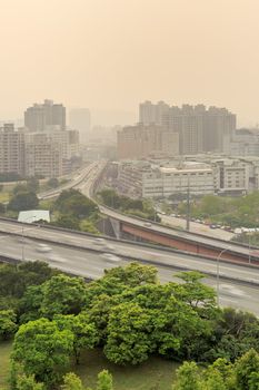 City scenery of sunset with buildings and high way under mist because air pollution in Taipei, Taiwan, Asia.